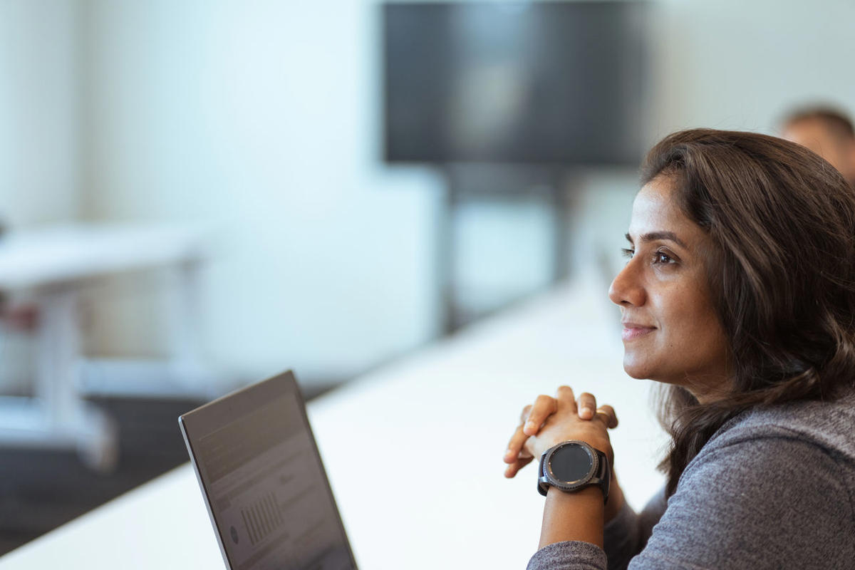 a woman looking at a laptop