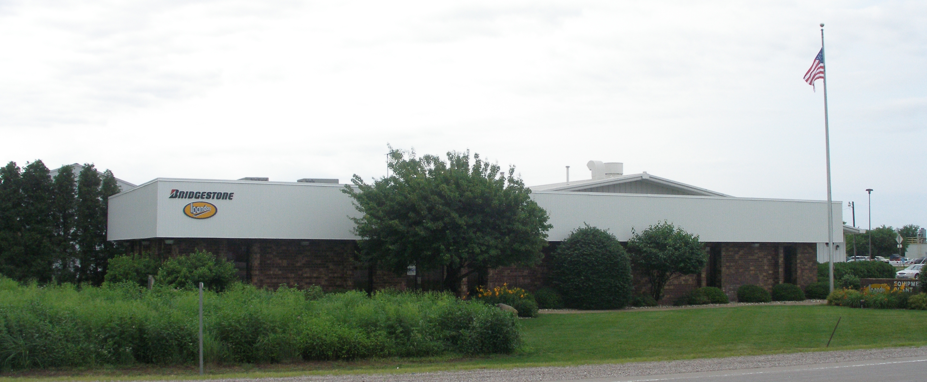 a building with a tree and bushes