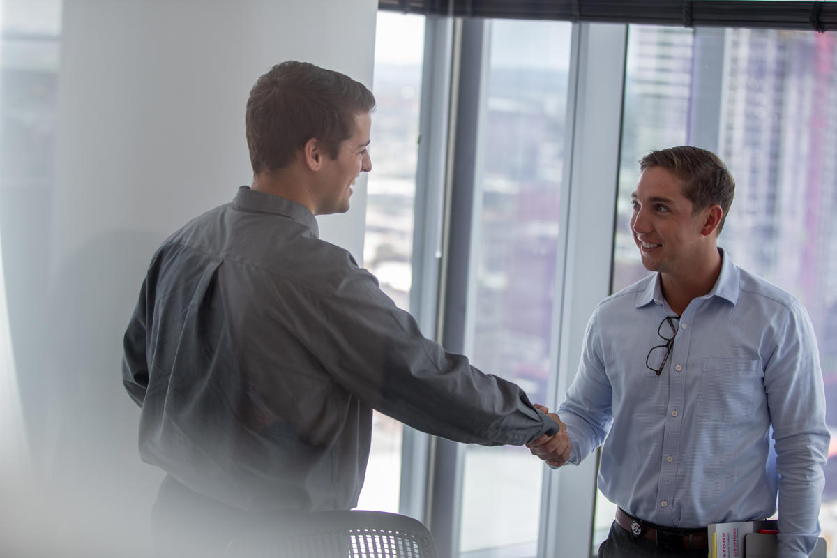 a man shaking hands with another man