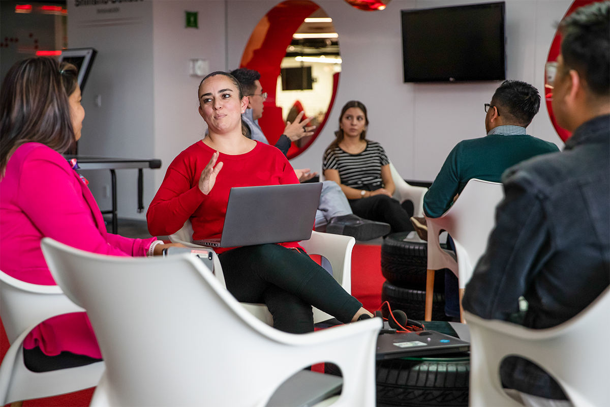 a woman sitting in chairs with a laptop