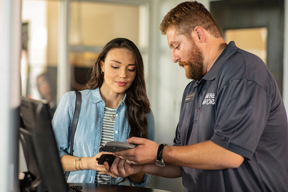a man and woman looking at a card