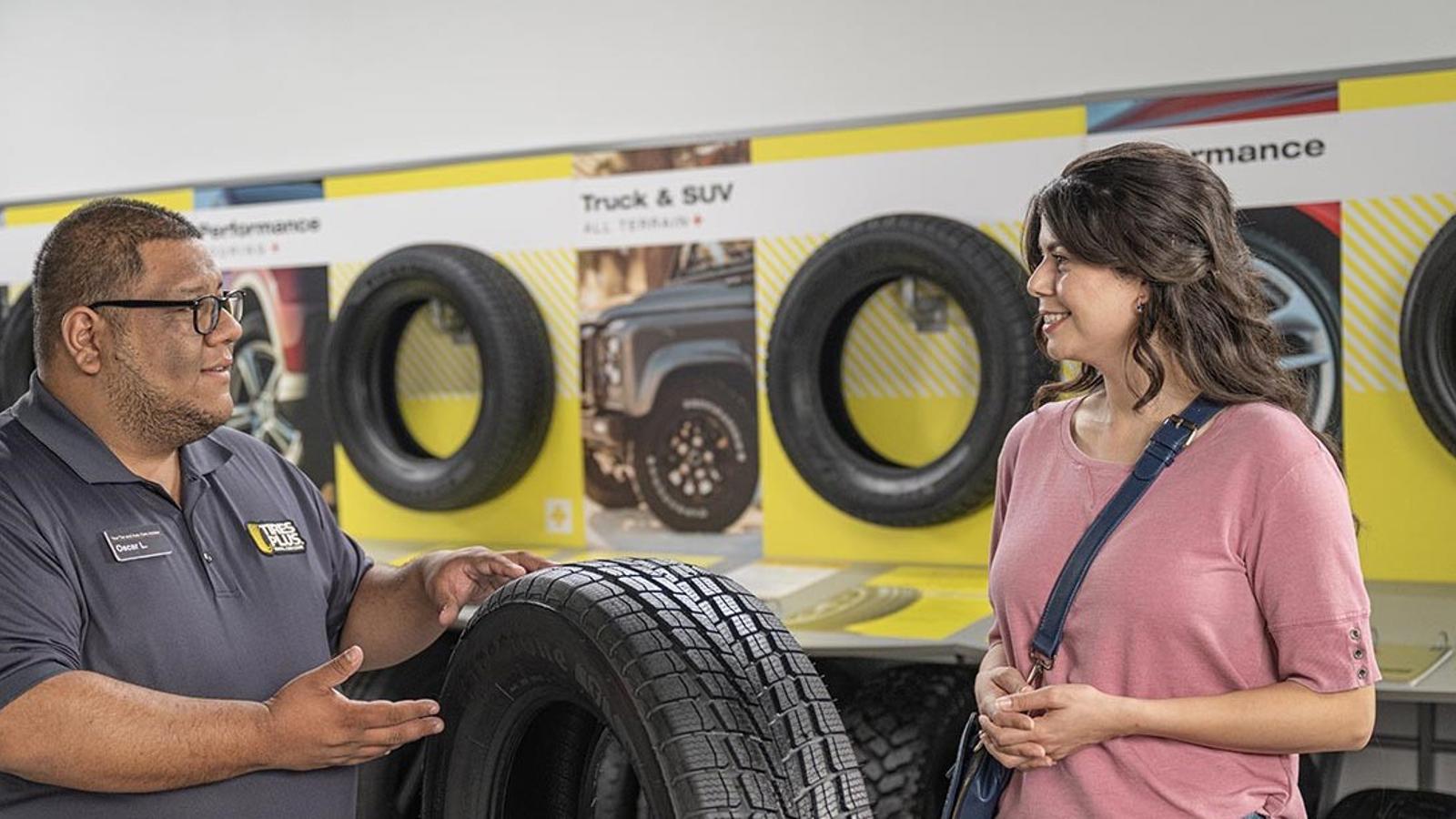 a man and woman looking at tires