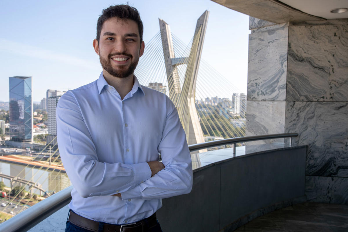 a man standing in front of a bridge