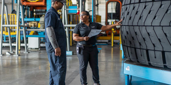 a man and woman standing in a factory