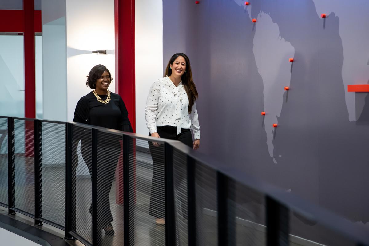 two women walking down a hallway
