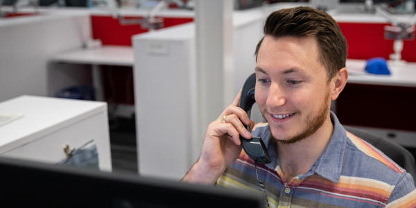 a man holding a phone to his ear