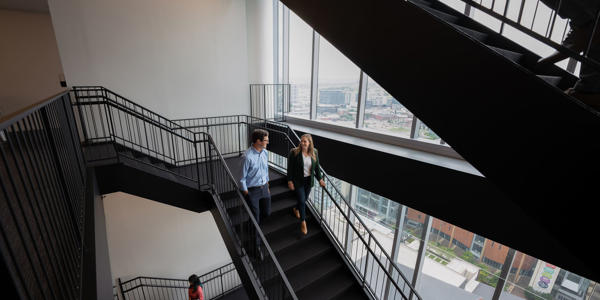 a man and woman walking up stairs
