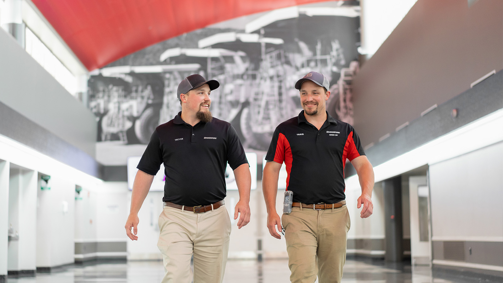 two men walking in a building