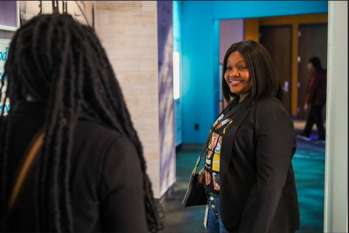 a woman looking at another woman