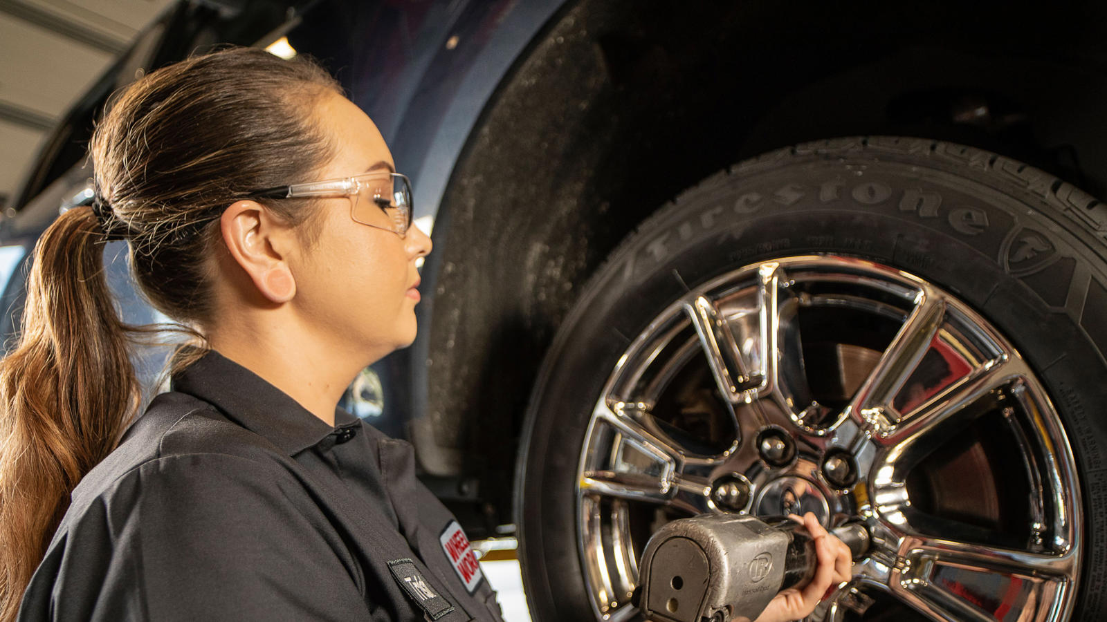 a woman working on a tire