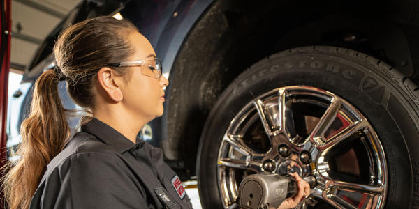 a woman working on a tire