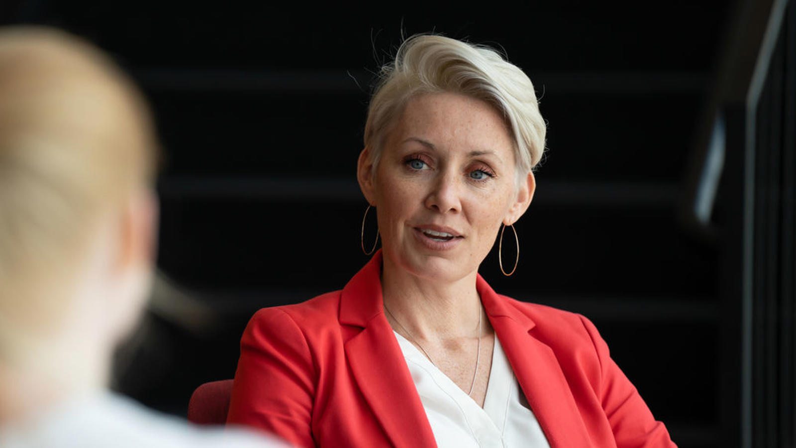 a woman in a red jacket